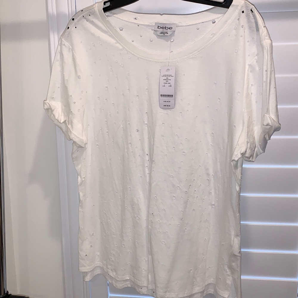 Bebe White cotton T-shirt short sleeve with holes. New with tags size large.